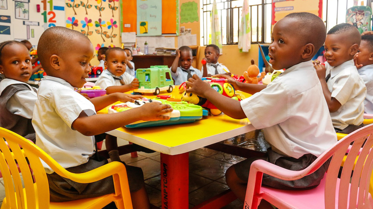 Pupils engaged in interactive learning in a bright nursery classroom